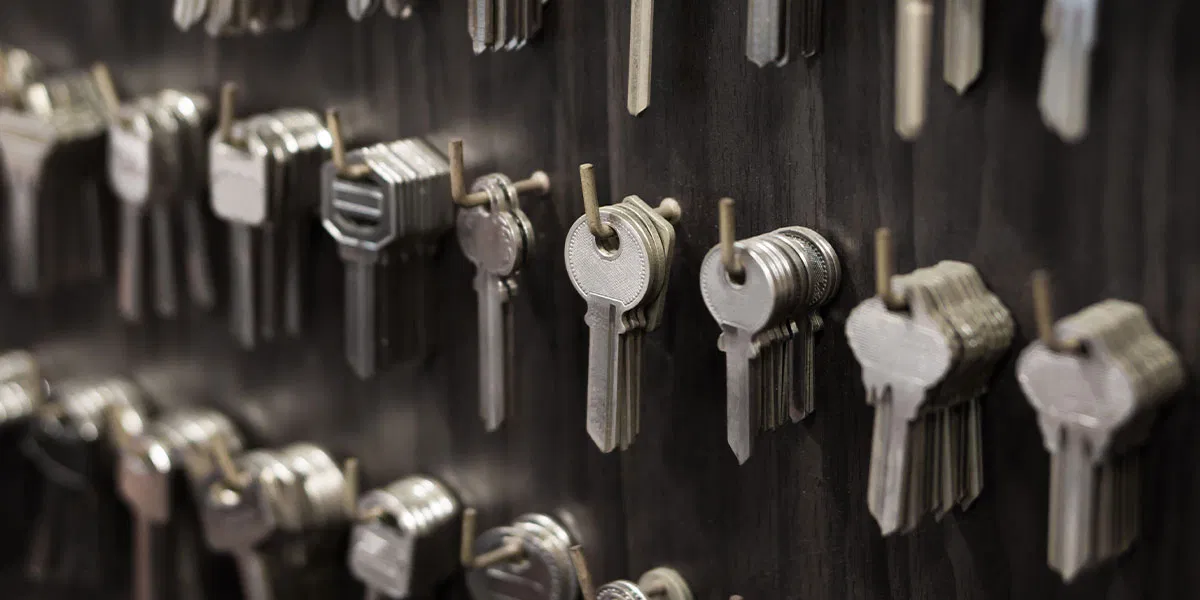 Organised wall of cut keys in a professional locksmith workshop